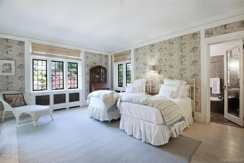 a spacious bedroom with a bed and a large window
