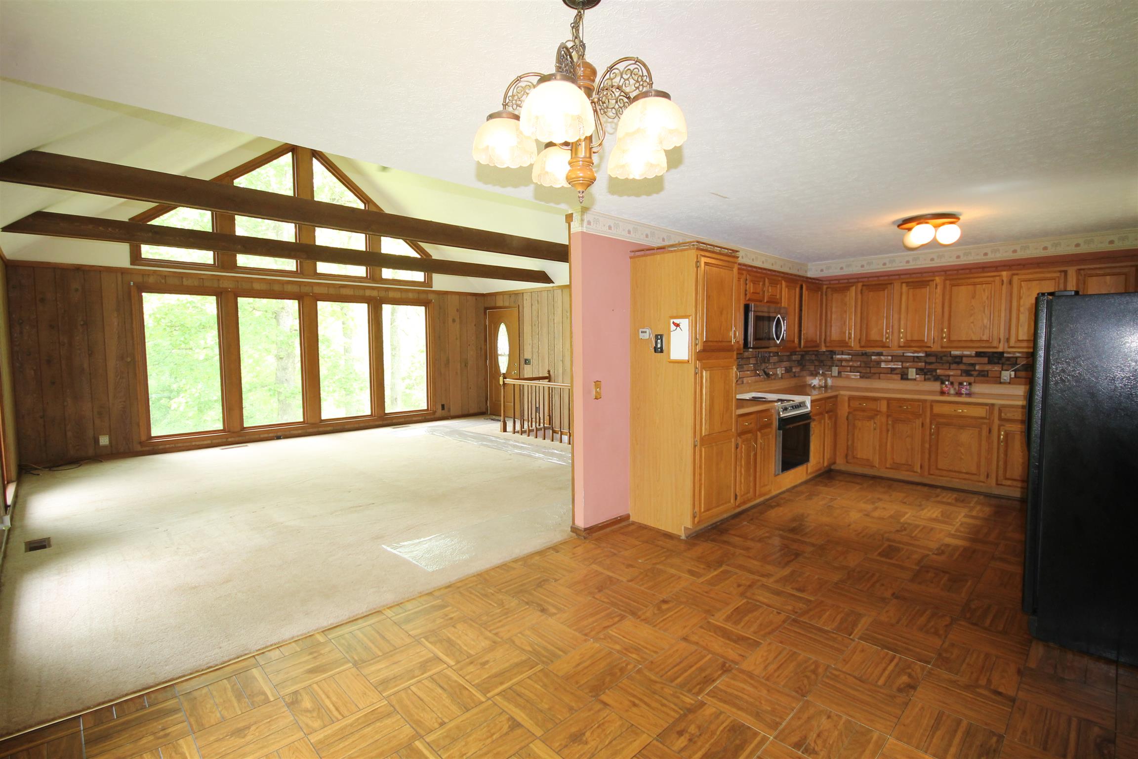 7184 Bahne Road Fairview, TN 37062 - Photo 4 of 14 a kitchen with stainless steel appliances granite countertop a stove kitchen island a refrigerator and a chandelier