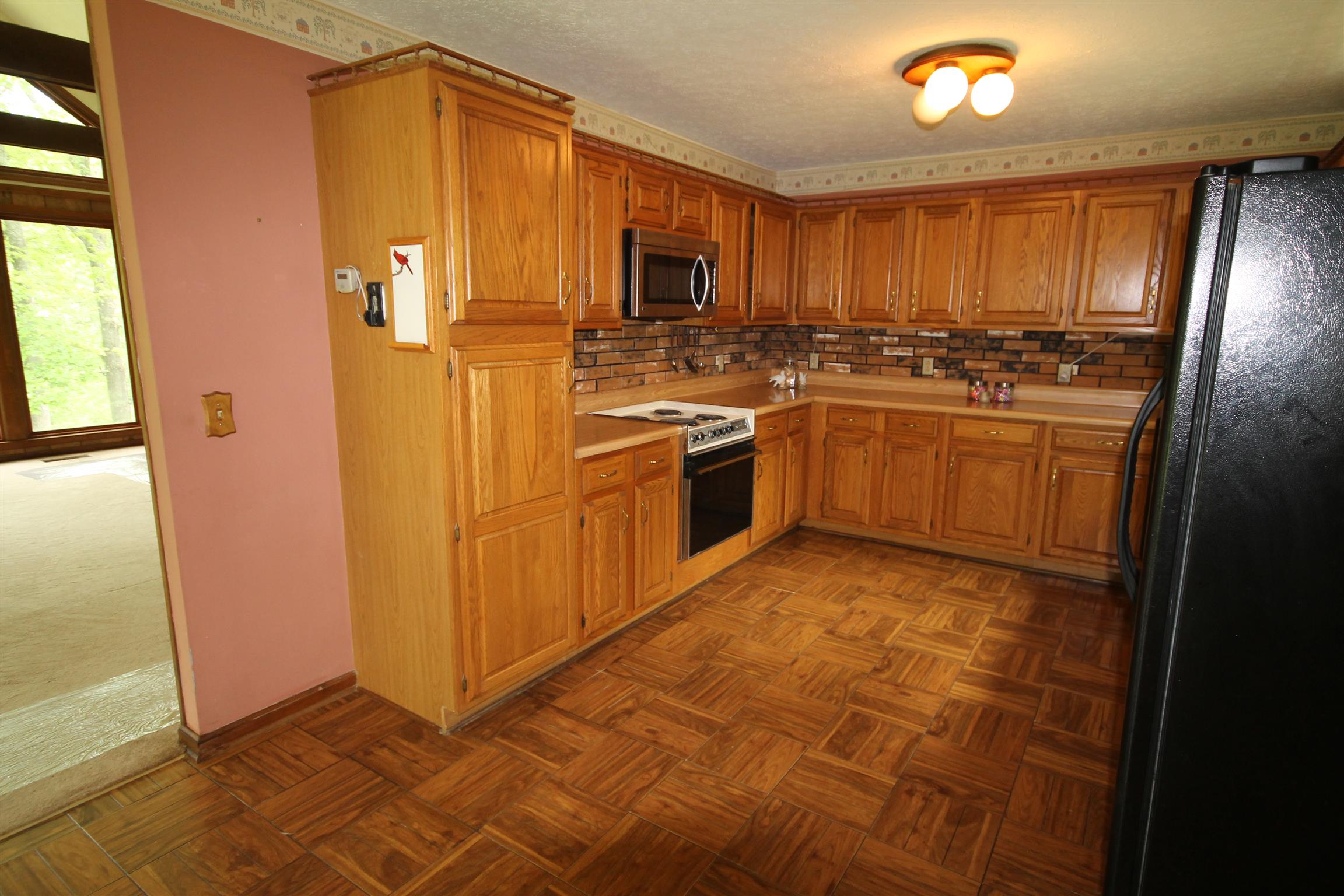 7184 Bahne Road Fairview, TN 37062 - Photo 5 of 14 a kitchen with stainless steel appliances granite countertop a refrigerator a stove top oven a sink and dishwasher