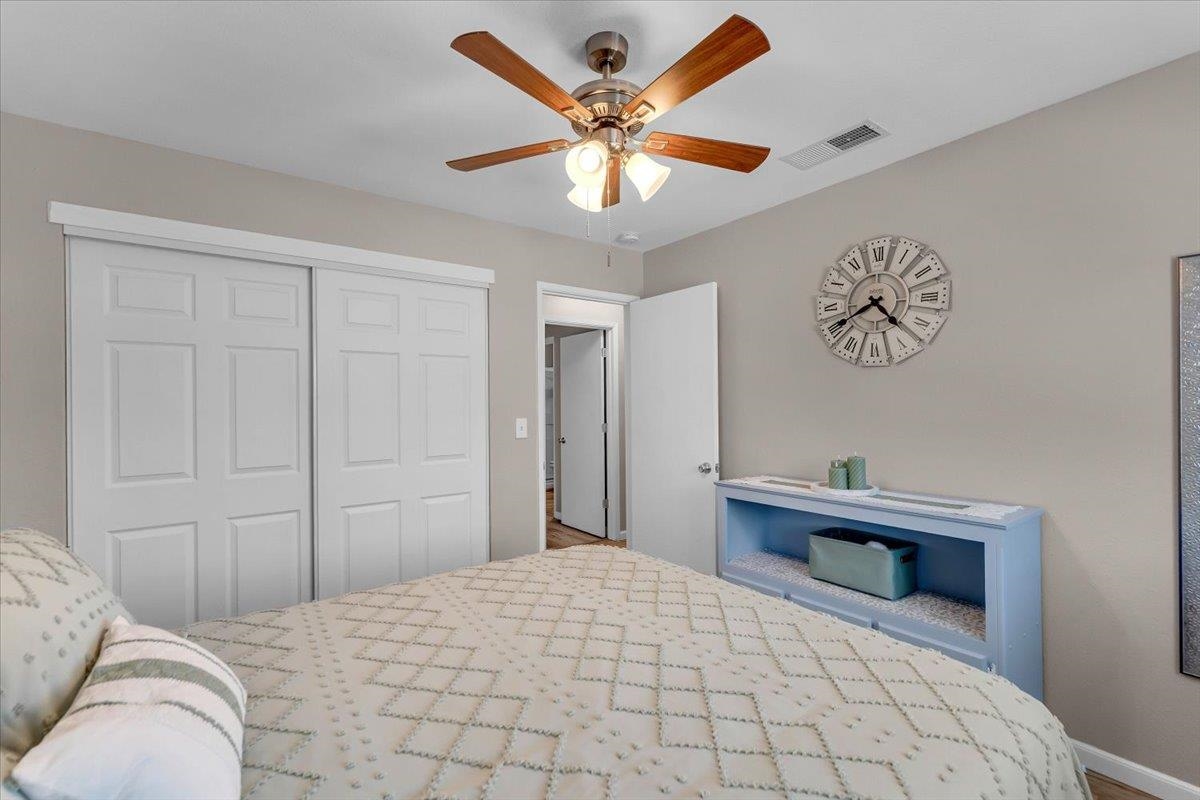 2110 Gentry Way Red Bluff, CA 96080 - Photo 21 of 47 a bedroom with a bed and a chandelier