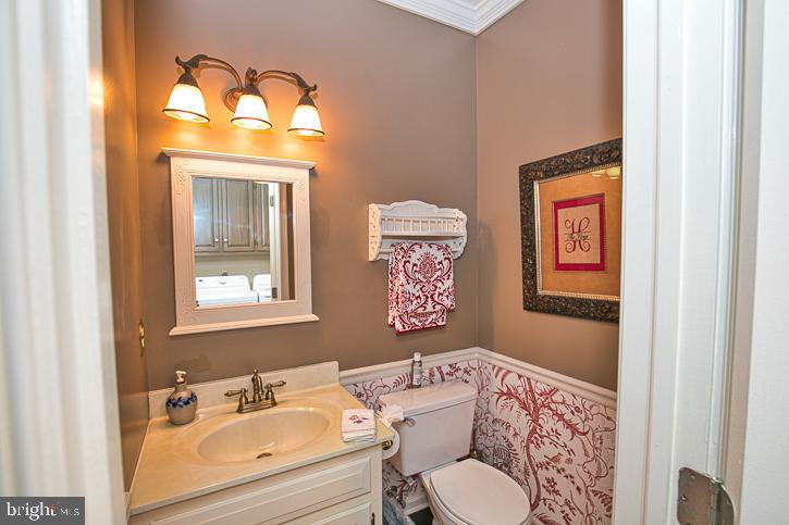 3589 Union Church Road Salisbury, MD 21804 - Photo 31 of 84 a bathroom with a granite countertop toilet a sink and a mirror