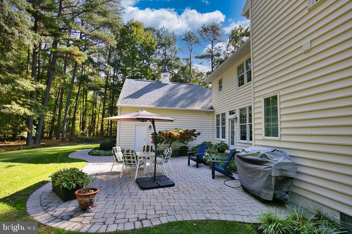 3589 Union Church Road Salisbury, MD 21804 - Photo 75 of 84 a view of a patio with table and chairs potted plants and large tree
