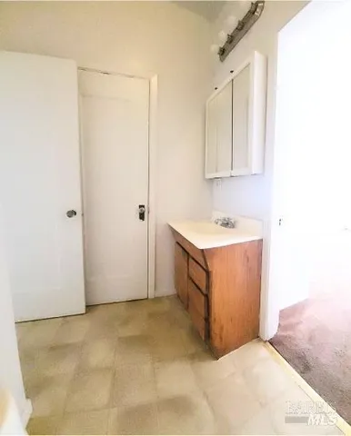 a bathroom with a bathtub and next to a window