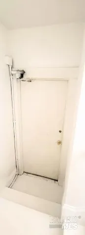 a utility room with refrigerator and washer