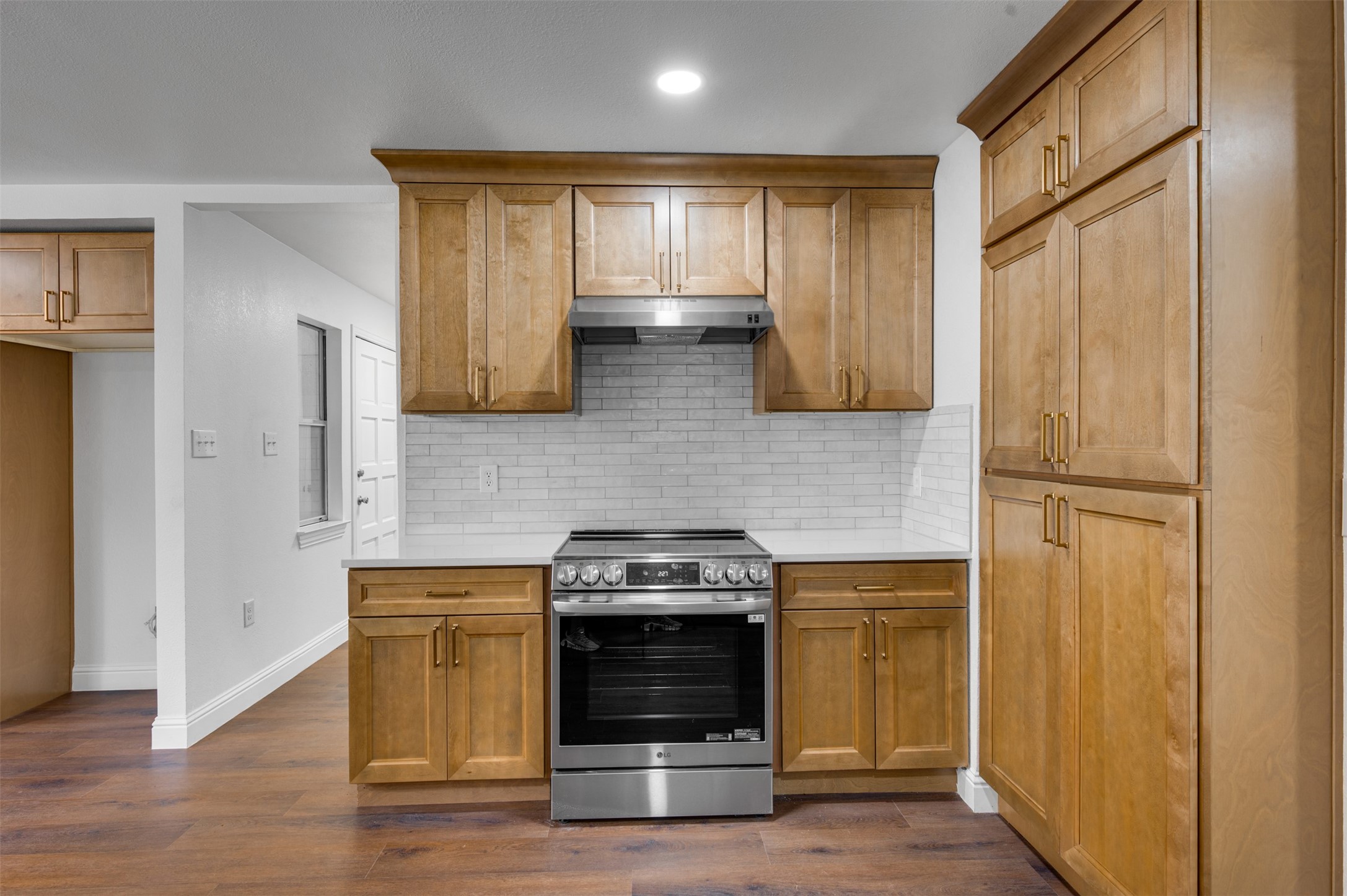 302 An County Road 3914 Palestine, TX 75801 - Photo 14 of 44 a kitchen with stainless steel appliances wooden floor sink and wooden cabinets
