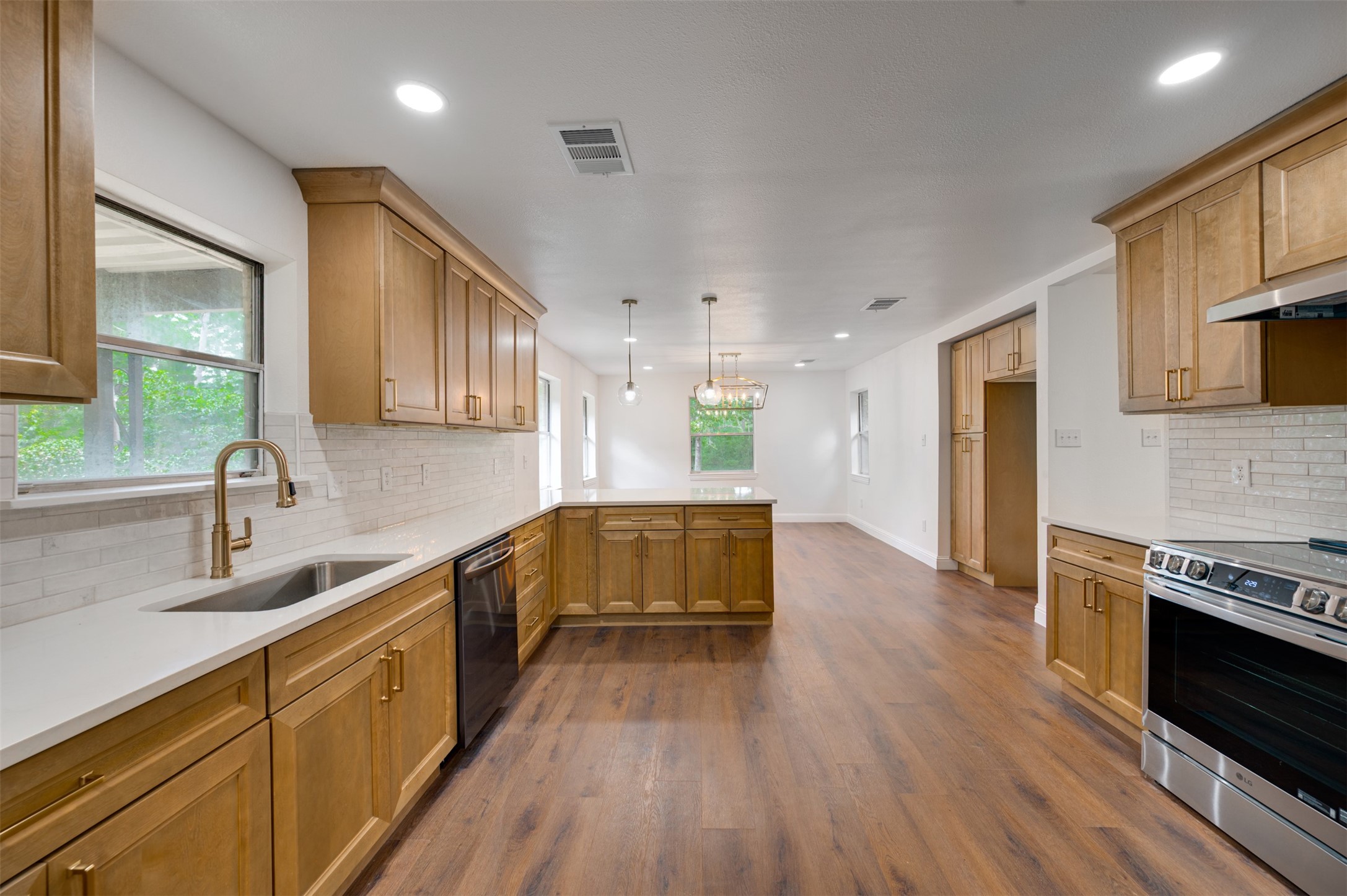 302 An County Road 3914 Palestine, TX 75801 - Photo 16 of 44 a kitchen with stainless steel appliances granite countertop wooden cabinets a stove top oven a sink and dishwasher