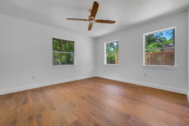 a view of room with hardwood floor and ceiling fan