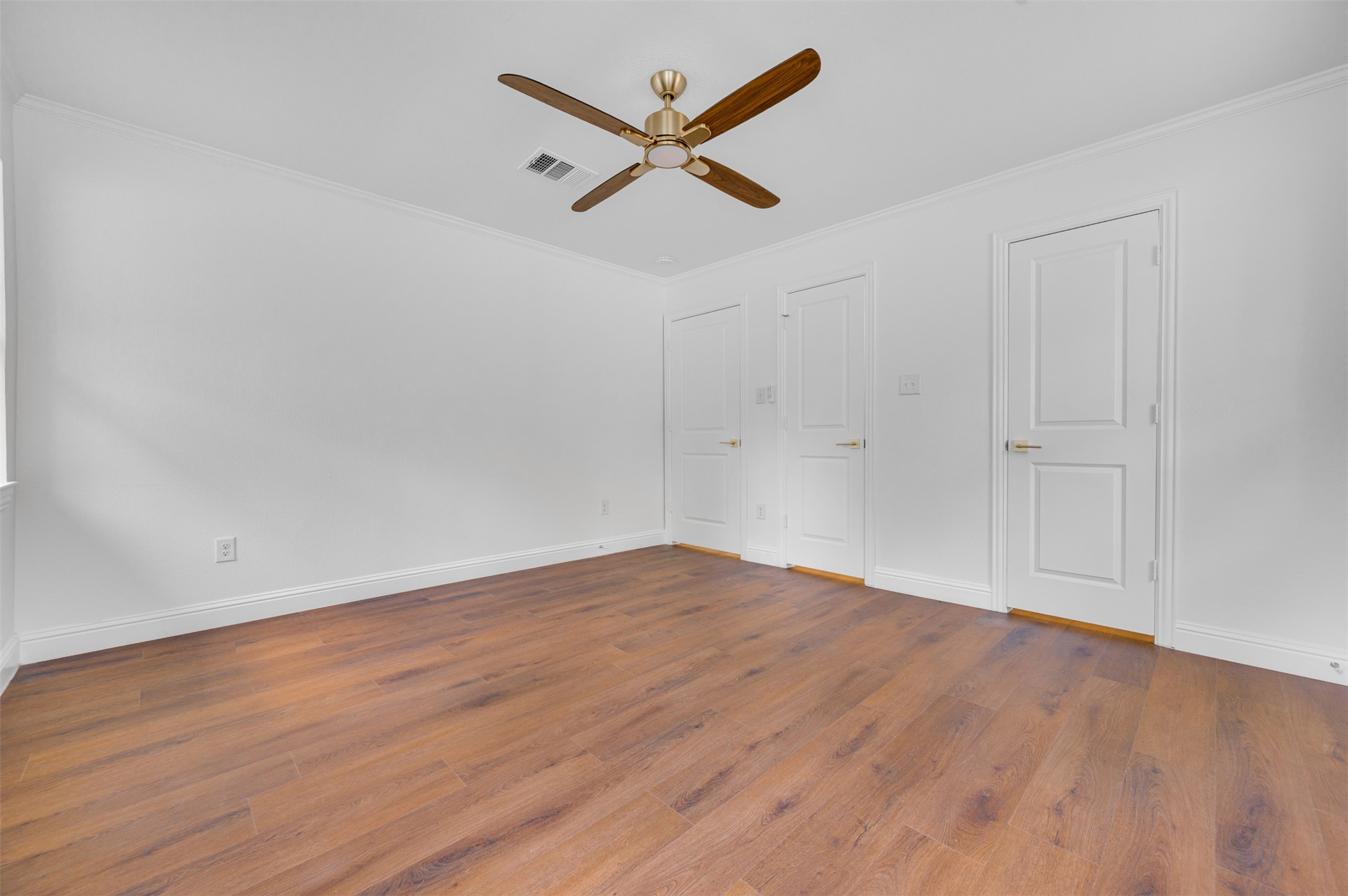 302 An County Road 3914 Palestine, TX 75801 - Photo 26 of 44 an empty room with wooden floor and ceiling fan