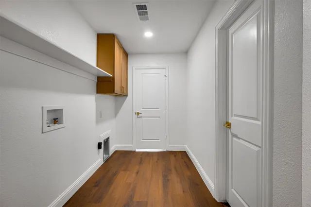 a view of a hallway with wooden floor and closet