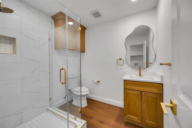 a bathroom with a toilet sink and mirror