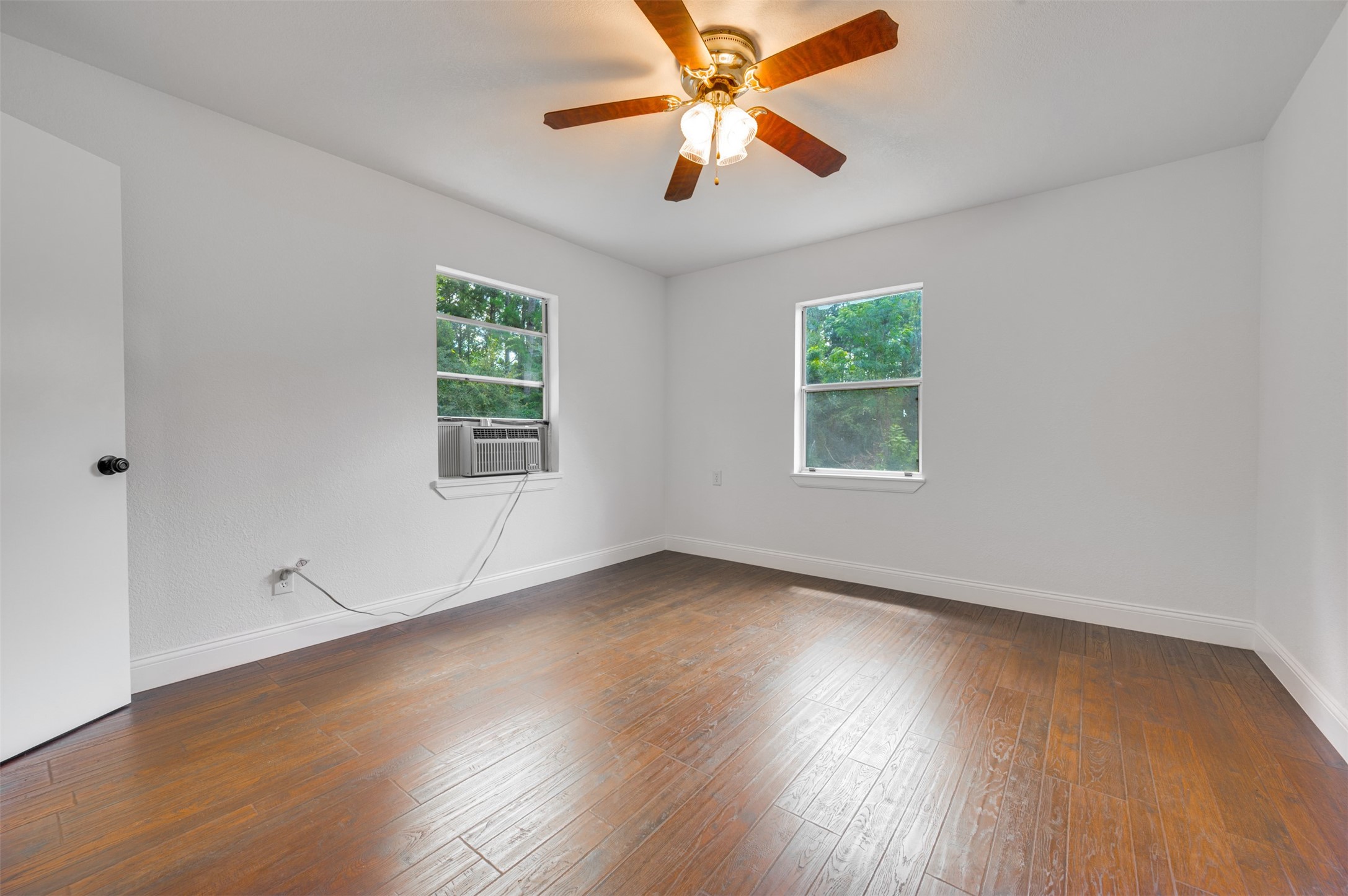 302 An County Road 3914 Palestine, TX 75801 - Photo 33 of 44 a view of an empty room with wooden floor and a window