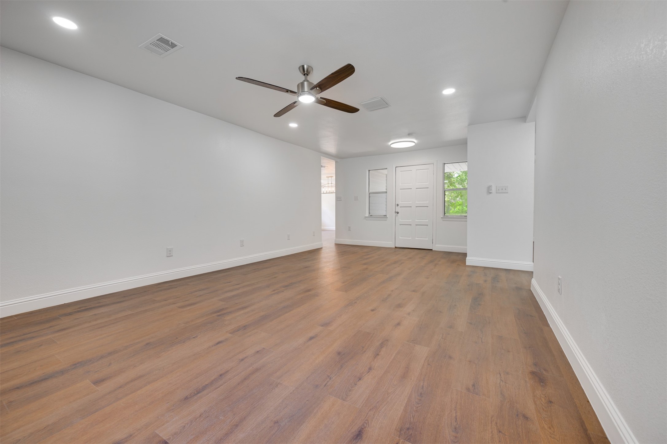 302 An County Road 3914 Palestine, TX 75801 - Photo 8 of 44 a view of an empty room with wooden floor and a window