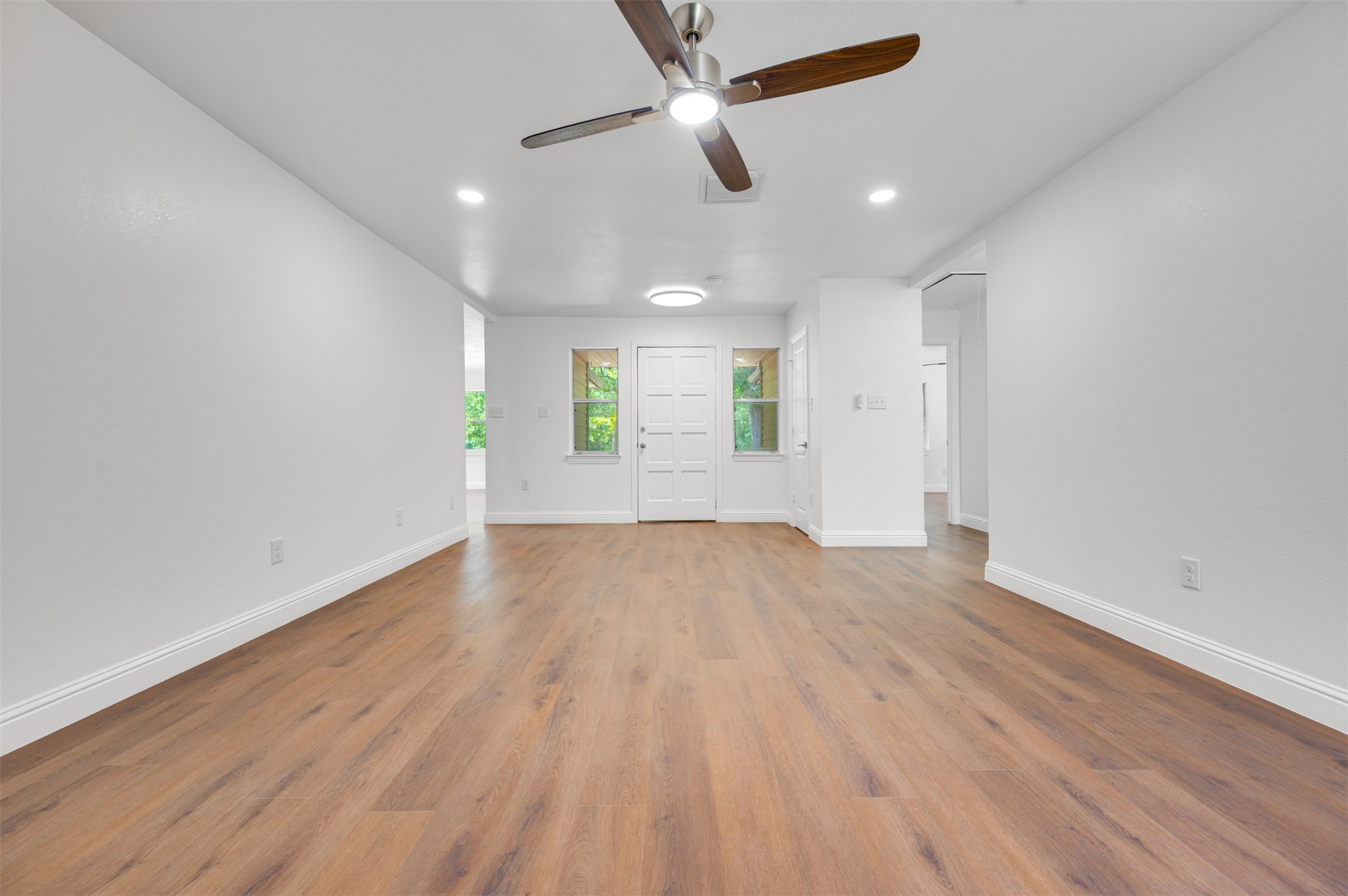 302 An County Road 3914 Palestine, TX 75801 - Photo 9 of 44 wooden floor in an empty room with a window