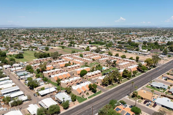 an aerial view of residential houses with outdoor space