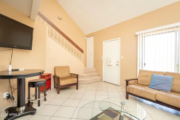 a bed sitting in a bedroom next to a window with lamp
