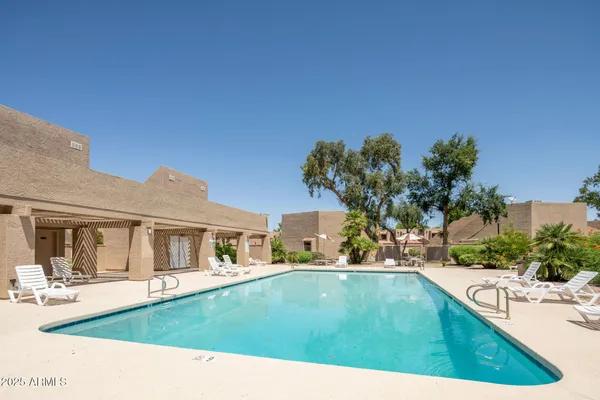 a view of a swimming pool and lounge chair