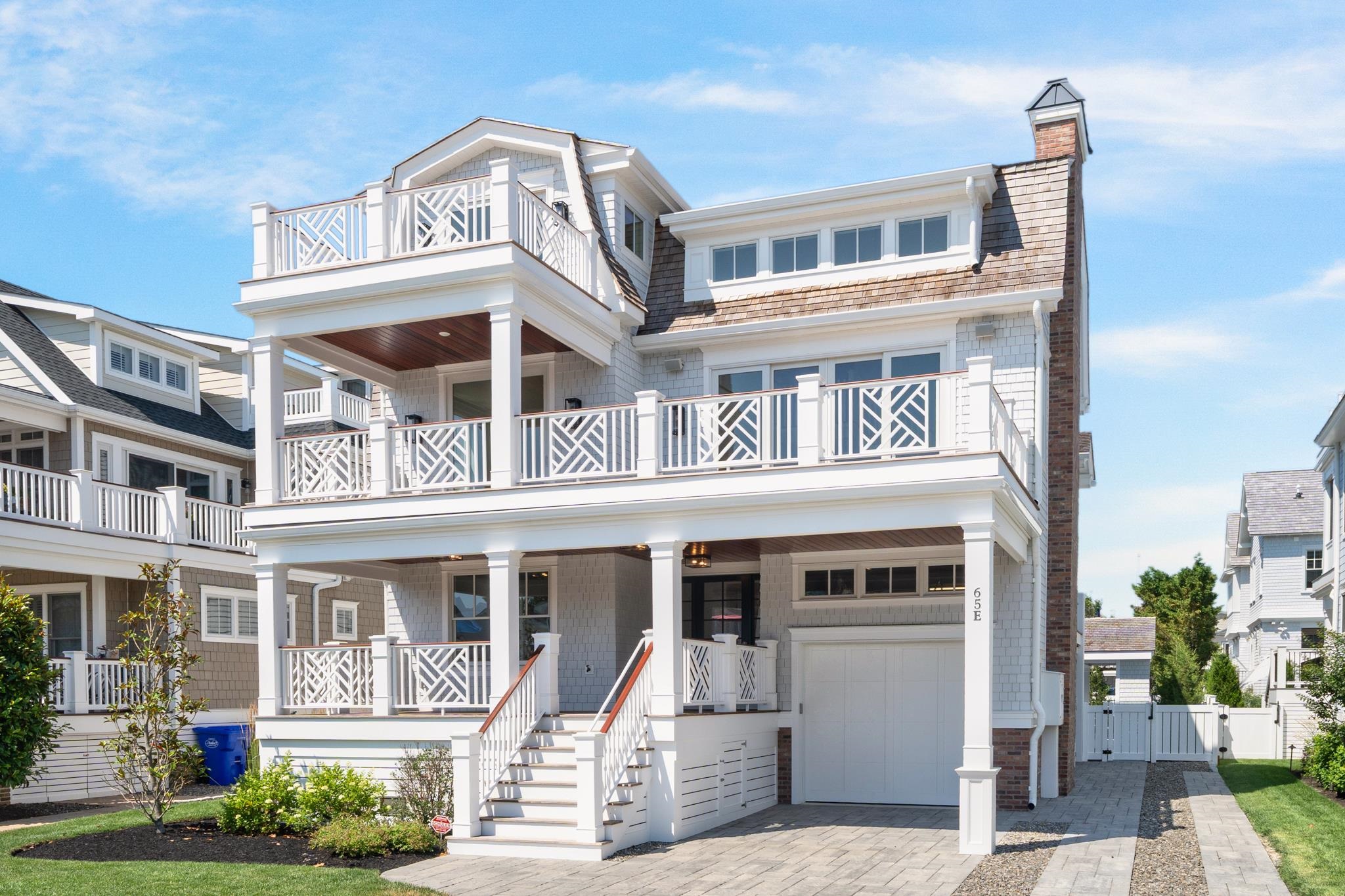 65 East 24th Avalon, NJ 08202 - Photo 1 of 49 a front view of a residential apartment building with a yard