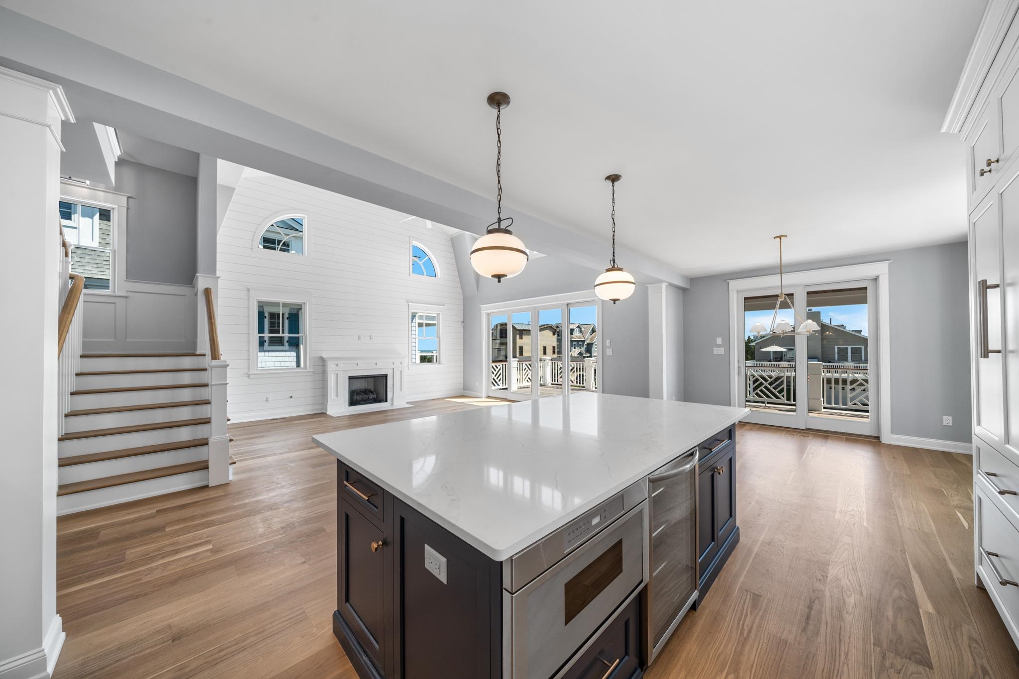 65 East 24th Avalon, NJ 08202 - Photo 19 of 49 a kitchen with a stove center island wooden floor and cabinets