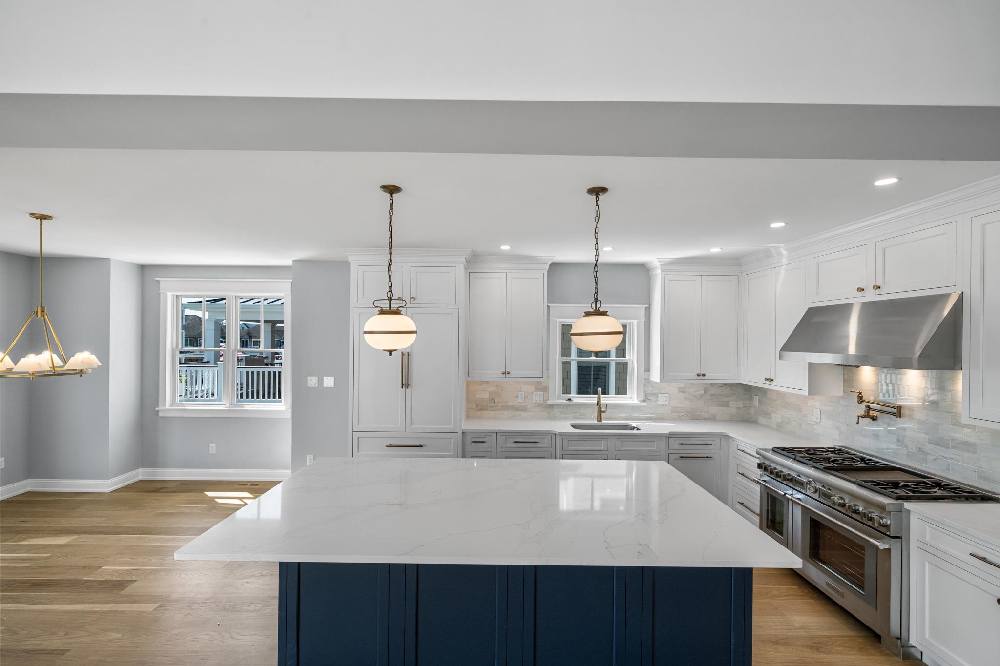 65 East 24th Avalon, NJ 08202 - Photo 21 of 49 a large kitchen with stainless steel appliances granite countertop a stove a sink and a wooden floors