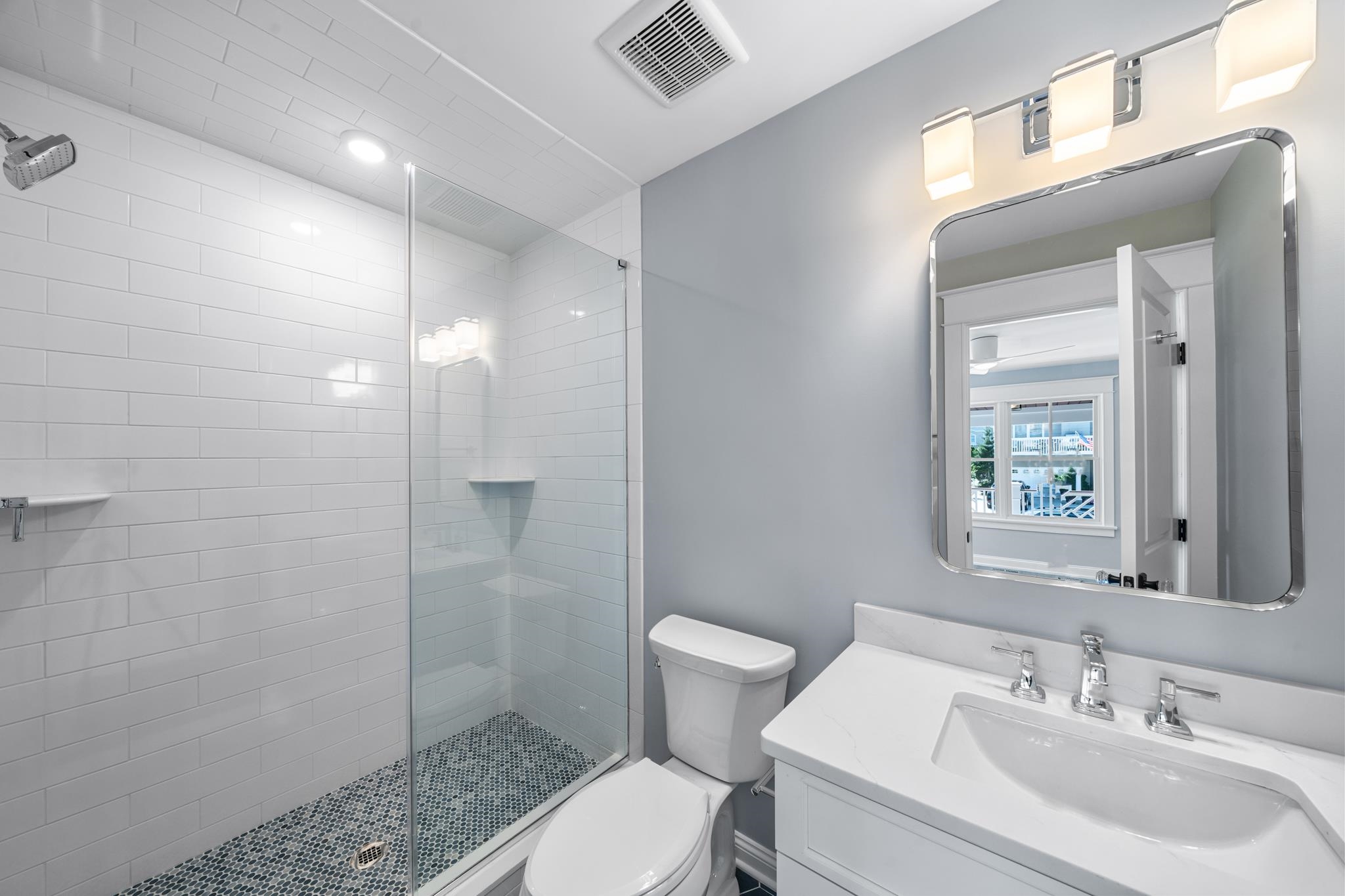 65 East 24th Avalon, NJ 08202 - Photo 30 of 49 a bathroom with a sink toilet and shower