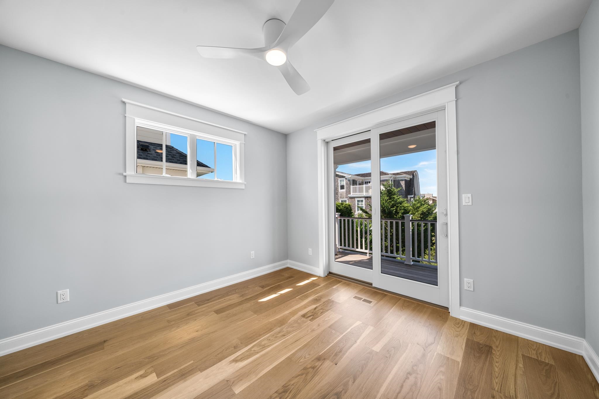 65 East 24th Avalon, NJ 08202 - Photo 35 of 49 a view of an empty room with a window and hardwood floor