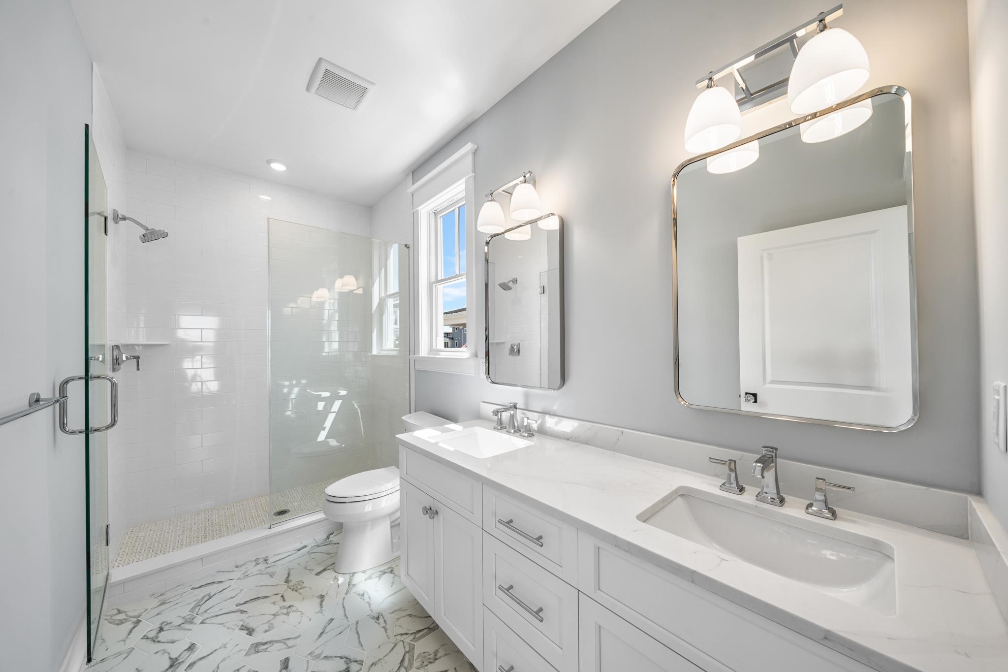 65 East 24th Avalon, NJ 08202 - Photo 37 of 49 a spacious bathroom with a double vanity sink toilet mirror and shower