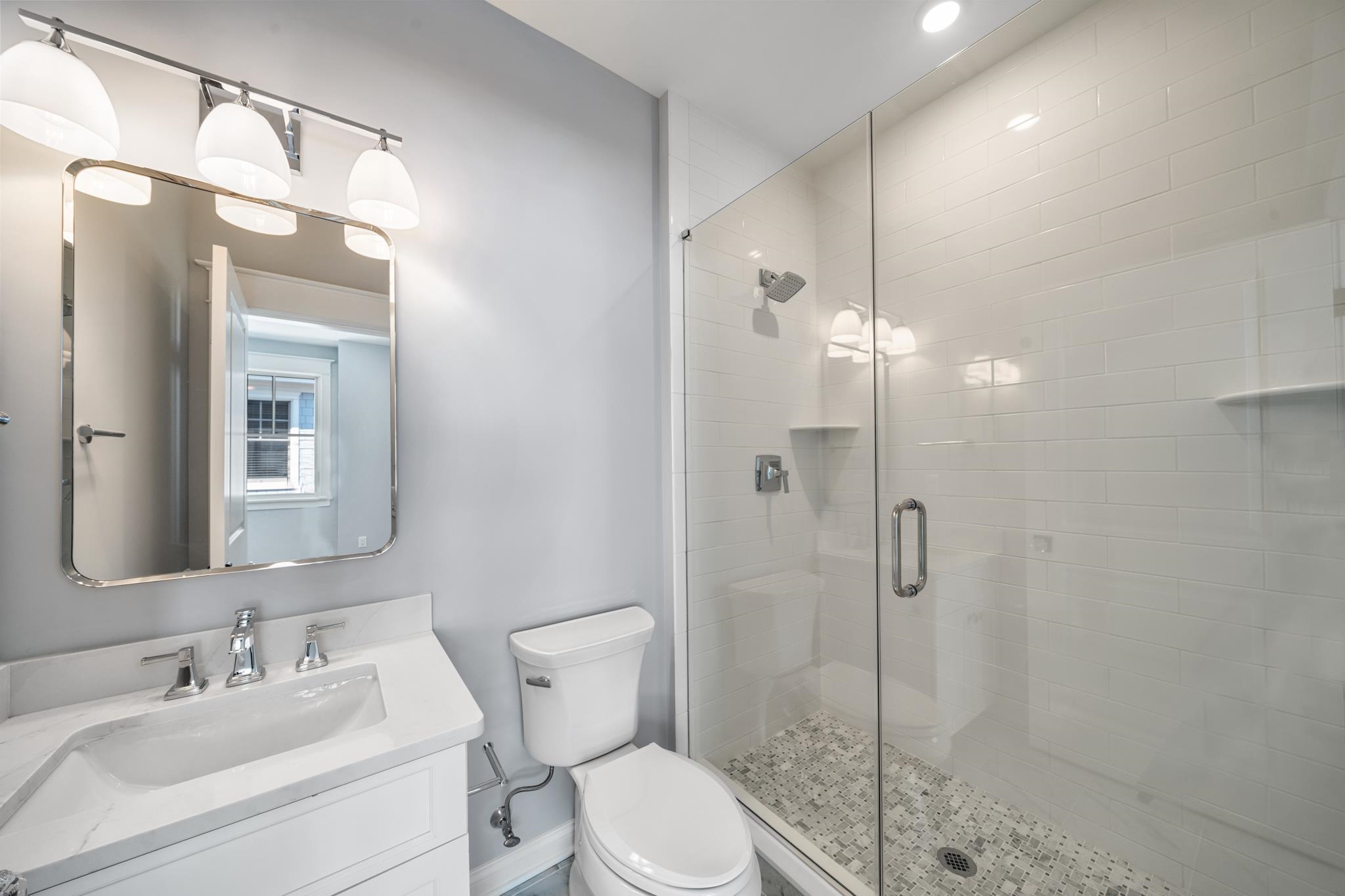 65 East 24th Avalon, NJ 08202 - Photo 40 of 49 a bathroom with a toilet a sink and shower