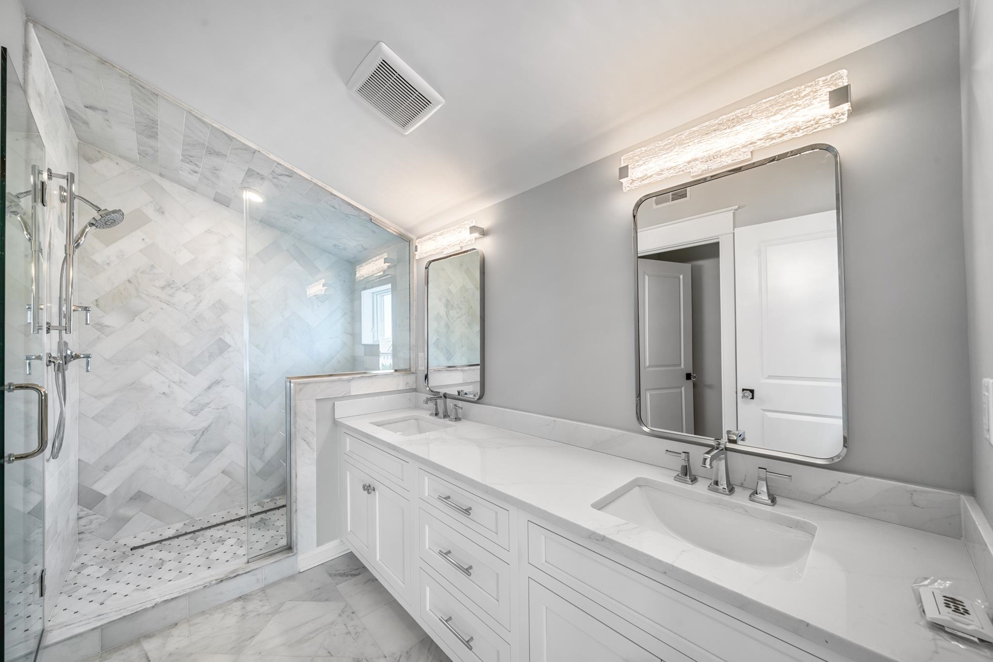 65 East 24th Avalon, NJ 08202 - Photo 44 of 49 a bathroom with double vanity sinks and a mirror