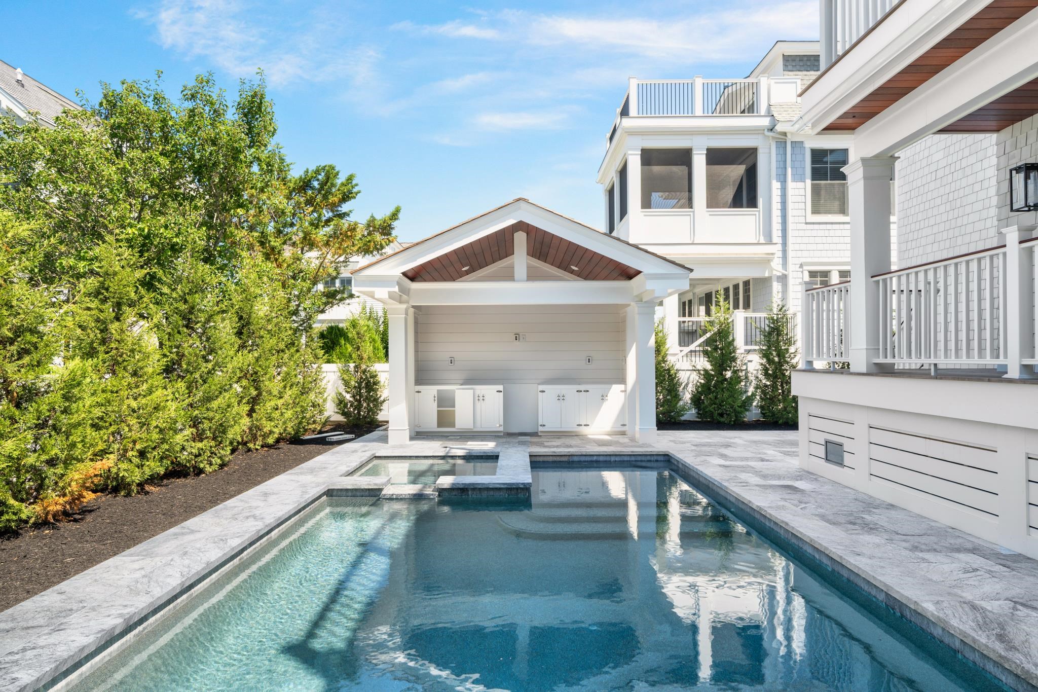65 East 24th Avalon, NJ 08202 - Photo 8 of 49 a view of house with yard outdoor seating and covered with trees