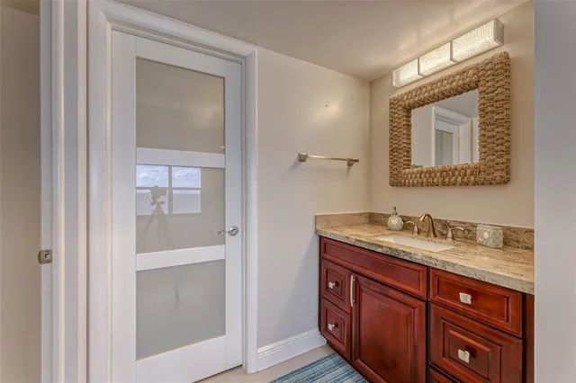 a view of a patio with dining table and chairs under an umbrella with a fire pit