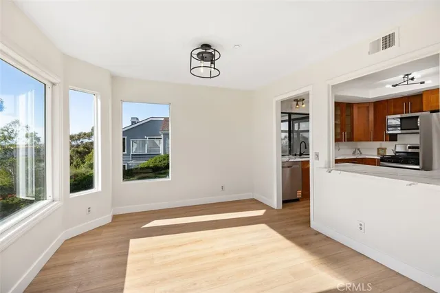 a view of a kitchen with refrigerator and windows