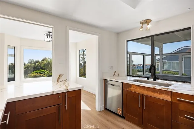 a kitchen with sink and large window