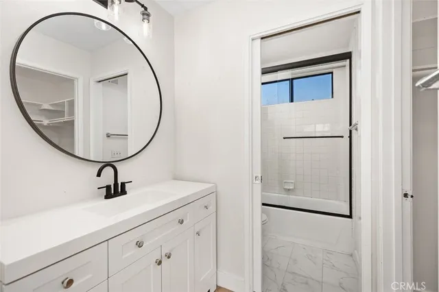 a bathroom with a sink a mirror and a shower