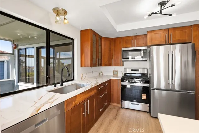 a kitchen with stainless steel appliances a sink stove and refrigerator