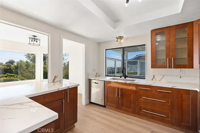 a kitchen with stainless steel appliances granite countertop a sink stove and wooden cabinets