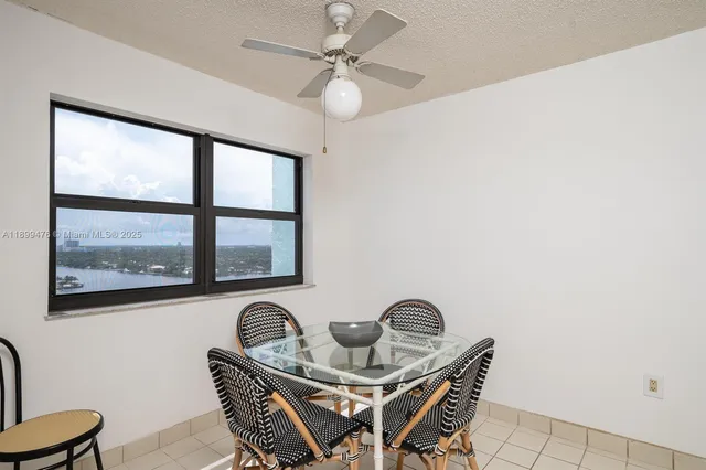a dining room with furniture and window