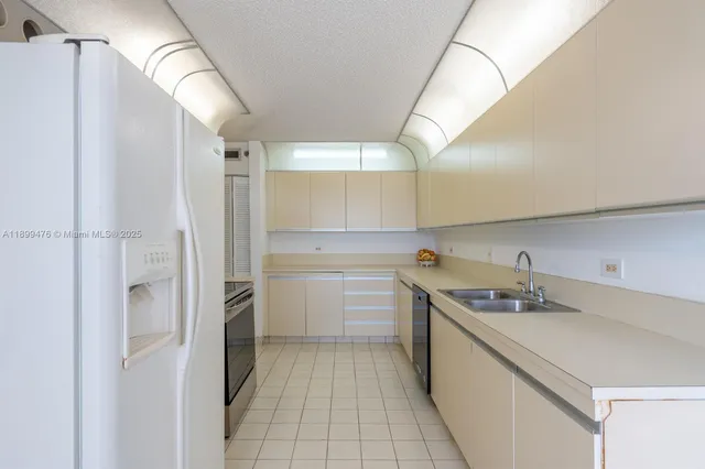a kitchen with a sink and refrigerator