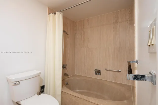 a bathroom with a bathtub and a toilet