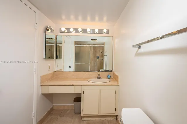 a bathroom with a sink a toilet and mirror