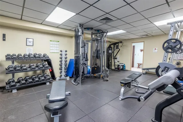 a room with gym equipment and large mirror