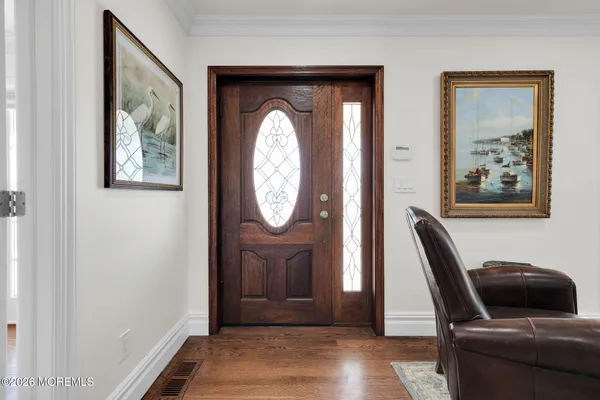 a view of a dining room with furniture wooden floor and chandelier