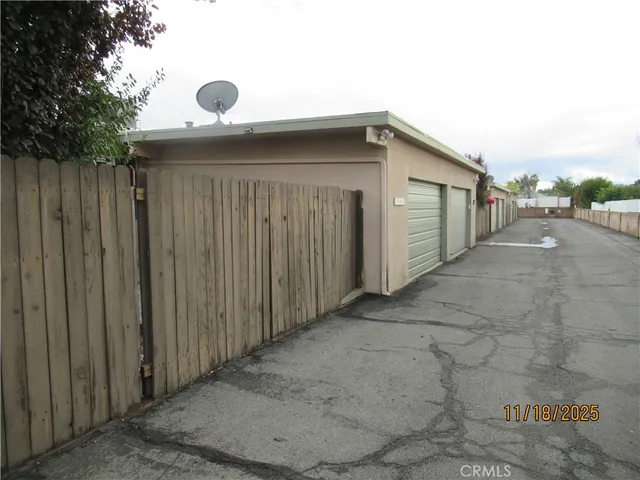 a view of a backyard with wooden fence