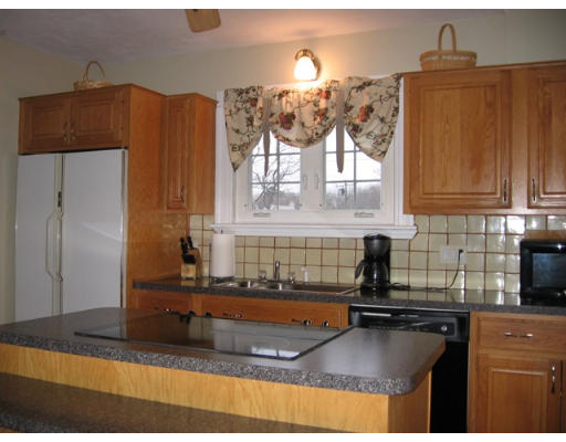 52 Thorndyke Road Worcester, MA 01606 - Photo 3 of 16 a kitchen with kitchen island granite countertop a sink cabinets and window
