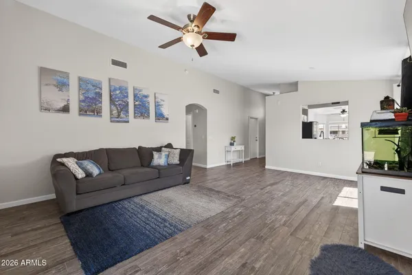 a living room with furniture and a wooden floor