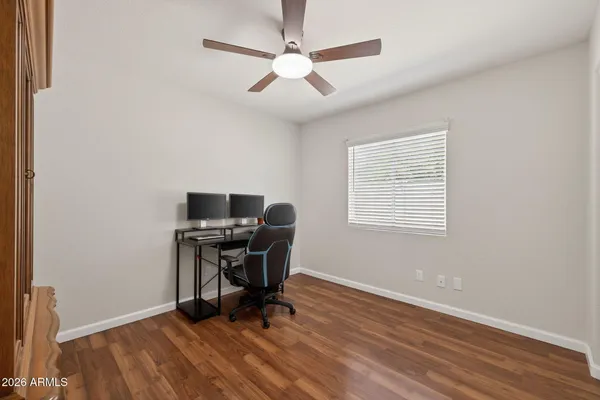 a view of a workspace with furniture and a window