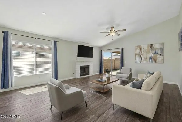 a living room with fireplace furniture and a window