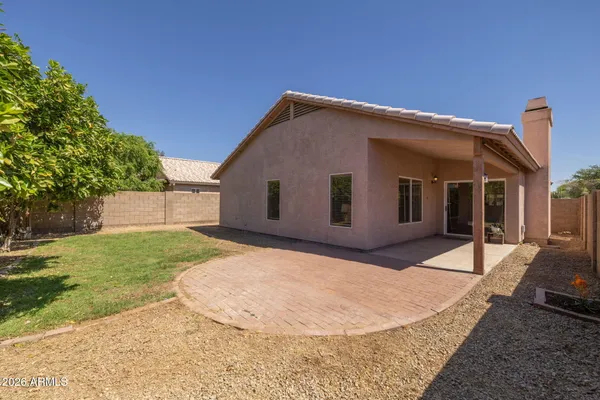 a view of a house with a backyard