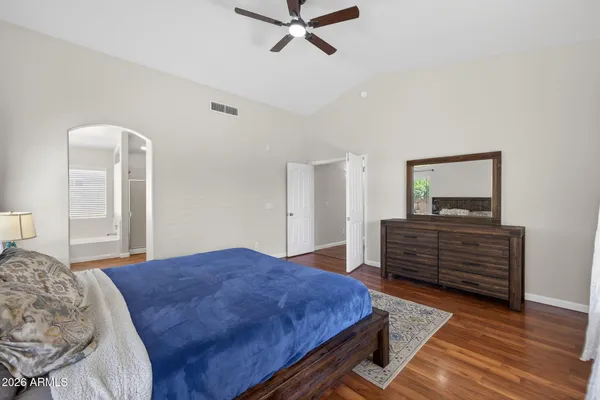 a bedroom with a bed and wooden floor