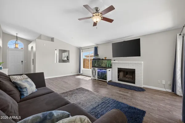 a living room with furniture a fireplace and a flat screen tv
