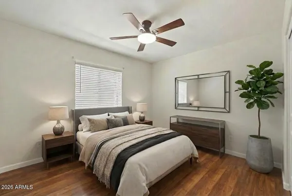 a bedroom with a bed and a potted plant